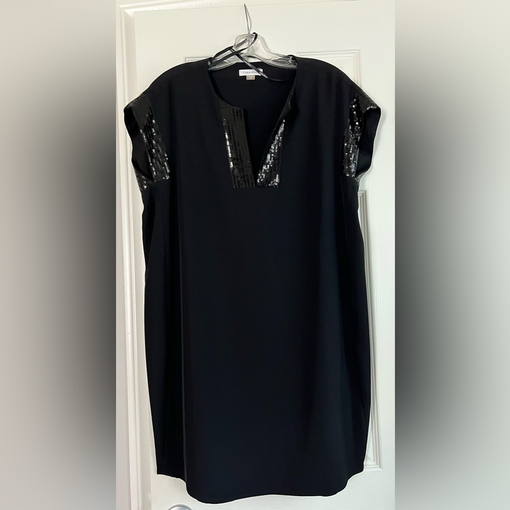 Calvin Klein black tunic style dress with sequin detail at neck and sleeve.